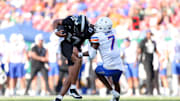 South Florida quarterback Byrum Brown runs over Boise State defensive back A'Marion McCoy.