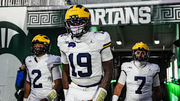 Michigan quarterback Bryce Underwood (19), center, quarterback Jadyn Davis (2), left, and quarterback Mikey Keene (7) take the field for warm up at Spartan Stadium in East Lansing on Saturday, October 25, 2025.