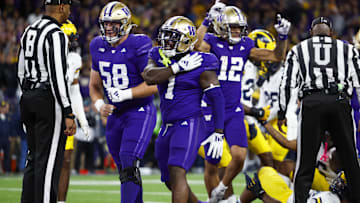 Oct 5, 2024; Seattle, Washington, USA; Washington Huskies running back Jonah Coleman (1) celebrates with offensive lineman Zachary Henning (58) after rushing for a touchdown against the Michigan Wolverines during the fourth quarter at Alaska Airlines Field at Husky Stadium. Mandatory Credit: Joe Nicholson-Imagn Images