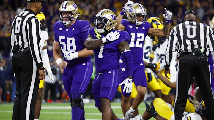 Oct 5, 2024; Seattle, Washington, USA; Washington Huskies running back Jonah Coleman (1) celebrates with offensive lineman Zachary Henning (58) after rushing for a touchdown against the Michigan Wolverines during the fourth quarter at Alaska Airlines Field at Husky Stadium. Mandatory Credit: Joe Nicholson-Imagn Images