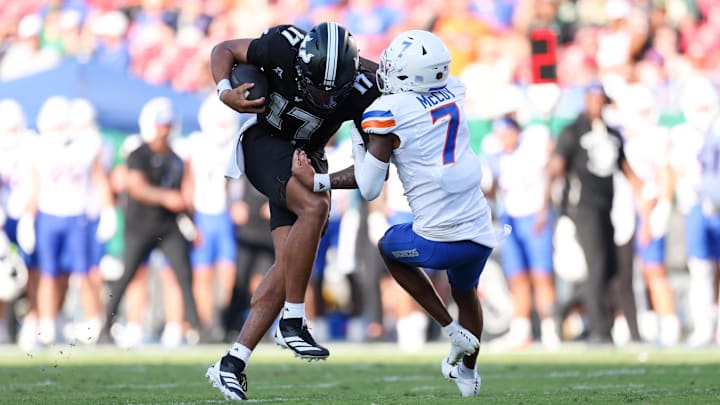 Aug 28, 2025; Tampa, Florida, USA; South Florida Bulls quarterback Byrum Brown (17) runs with the ball chased by Boise State Broncos defensive back A'Marion McCoy (7) in the second quarter against the Boise State Broncos in the second quarter at Raymond James Stadium. Mandatory Credit: Nathan Ray Seebeck-Imagn Images