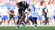 South Florida quarterback Byrum Brown runs over Boise State defensive back A'Marion McCoy.