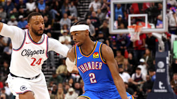 Mar 23, 2025; Inglewood, California, USA; Oklahoma City Thunder guard Shai Gilgeous-Alexander (2) drives against LA Clippers guard Norman Powell (24) during the 4th quarter at Intuit Dome. Mandatory Credit: Jason Parkhurst-Imagn Images