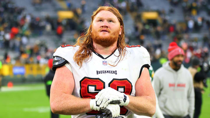 Cody Mauch #69 of the Tampa Bay Buccaneers leaves the field following a game against the Green Bay Packers at Lambeau Field on December 17, 2023 in Green Bay, Wisconsin.