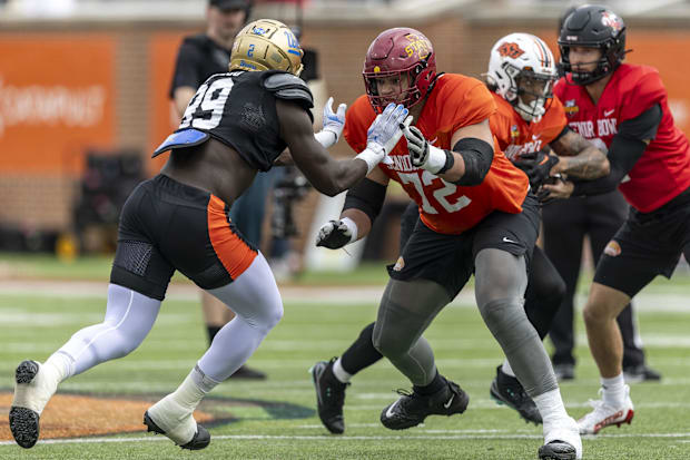 National team defensive lineman Oluwafemi Oladejo of UCLA and offensive lineman Jalen Travis of Iowa State work drills.