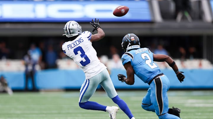 Oct 12, 2025; Charlotte, North Carolina, USA; Dallas Cowboys wide receiver George Pickens (3) makes a catch while being pressured Carolina Panthers cornerback Mike Jackson (2) during the second half at Bank of America Stadium. Mandatory Credit: Cory Knowlton-Imagn Images