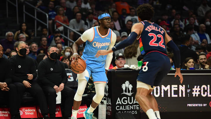 Mar 25, 2022; Los Angeles, California, USA; Los Angeles Clippers guard Reggie Jackson (1) controls the ball against Philadelphia 76ers guard Matisse Thybulle (22) during the first half at Crypto.com Arena. Mandatory Credit: Gary A. Vasquez-USA TODAY Sports