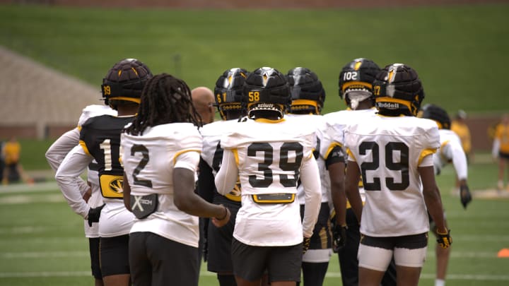 Players gather around running backs coach Curtis Luper at Missouri Tigers practice August, 13, 2024 at Faurot Field in Columbia, Mo.