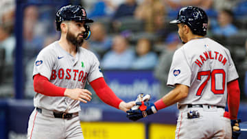 May 22, 2024; St. Petersburg, Florida, USA;  Boston Red Sox catcher Connor Wong (12) celebrates with shortstop David Hamilton (70) after scoring a run against the Tampa Bay Rays in the fifth inning at Tropicana Field. Mandatory Credit: Nathan Ray Seebeck-Imagn Images