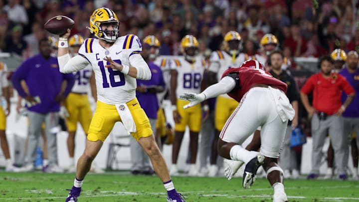 Nov 8, 2025; Tuscaloosa, Alabama, USA; Louisiana State Tigers quarterback Garrett Nussmeier (18) passes the ball defended by Alabama Crimson Tide defensive lineman Jordan Renaud (11) during the first quarter of the game at Saban Field at Bryant-Denny Stadium. Mandatory Credit: David Leong-Imagn Images