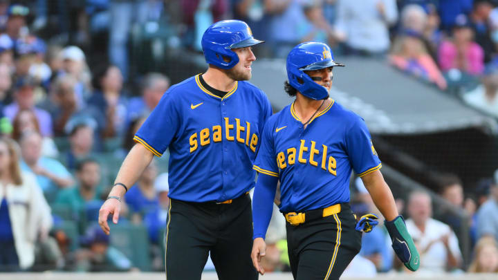 Seattle Mariners first baseman Luke Raley (20) and third baseman Josh Rojas (4) celebrate after both scored a run against the New York Mets during the sixth inning at T-Mobile Park on Aug 11.