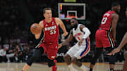 Mar 19, 2025; Miami, Florida, USA; Miami Heat forward Duncan Robinson (55) drives to the basket past Detroit Pistons forward Tim Hardaway Jr. (8) during the first quarter at Kaseya Center. Mandatory Credit: Sam Navarro-Imagn Images