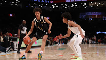 Apr 1, 2025; Brooklyn, NY, USA; McDonald's All American East forward Nate Ament (10) dribbles the ball against McDonald's All American West guard Mikel Brown Jr. (11) during the second half of the game at Barclays Center. Mandatory Credit: Pamela Smith-Imagn Images