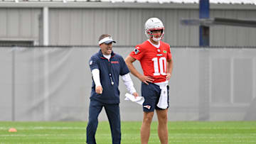 Jun 9, 2025; Foxborough, MA, USA; New England Patriots offensive coordinator Josh McDaniels directs a drill for quarterback Drake Maye (10) during minicamp at Gillette Stadium. Mandatory Credit: Eric Canha-Imagn Images