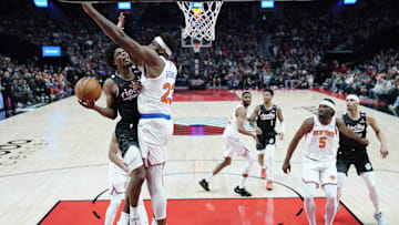Mar 12, 2025; Portland, Oregon, USA; Portland Trail Blazers guard Scoot Henderson (00, left) shoots the ball against New York Knicks center Mitchell Robinson (23) during the first half at Moda Center. Mandatory Credit: Soobum Im-Imagn Images