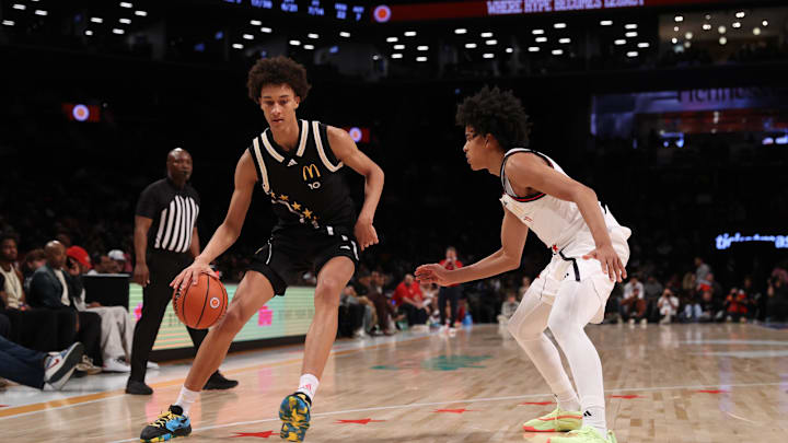 Apr 1, 2025; Brooklyn, NY, USA; McDonald's All American East forward Nate Ament (10) dribbles the ball against McDonald's All American West guard Mikel Brown Jr. (11) during the second half of the game at Barclays Center. Mandatory Credit: Pamela Smith-Imagn Images