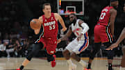 Mar 19, 2025; Miami, Florida, USA; Miami Heat forward Duncan Robinson (55) drives to the basket past Detroit Pistons forward Tim Hardaway Jr. (8) during the first quarter at Kaseya Center. Mandatory Credit: Sam Navarro-Imagn Images