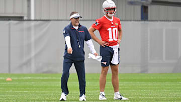 Jun 9, 2025; Foxborough, MA, USA; New England Patriots offensive coordinator Josh McDaniels directs a drill for quarterback Drake Maye (10) during minicamp at Gillette Stadium. Mandatory Credit: Eric Canha-Imagn Images