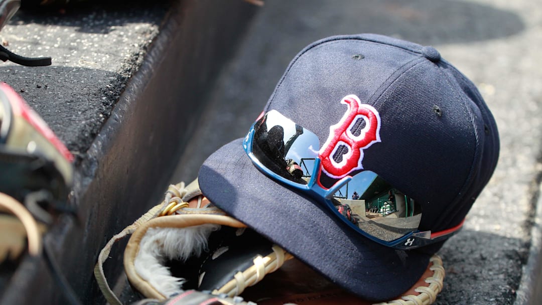 Mar 7, 2015; Sarasota, FL, USA; A general view of  Boston Red Sox hat and glove laying in the dugout at a spring training baseball game at Ed Smith Stadium. Mandatory Credit: Kim Klement-Imagn Images