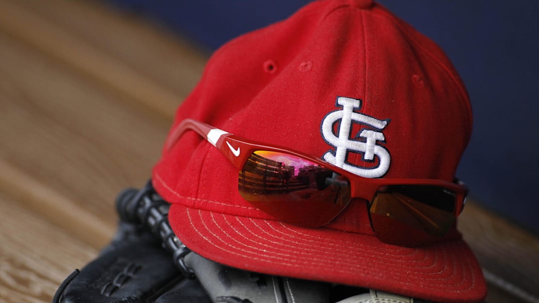 Jul 27, 2013; Atlanta, GA, USA; Detailed view of St. Louis Cardinals cap and glove in the dugout before a game against the Atlanta Braves at Turner Field. Mandatory Credit: Brett Davis-Imagn Images