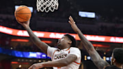 Feb 8, 2025; Louisville, Kentucky, USA;  Miami (Fl) Hurricanes forward Brandon Johnson (2) shoots against Louisville Cardinals forward James Scott (0) during the first half at KFC Yum! Center. Mandatory Credit: Jamie Rhodes-Imagn Images