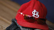 Jul 27, 2013; Atlanta, GA, USA; Detailed view of St. Louis Cardinals cap and glove in the dugout before a game against the Atlanta Braves at Turner Field. Mandatory Credit: Brett Davis-Imagn Images