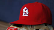 Oct 4, 2015; Atlanta, GA, USA; Detailed view of St. Louis Cardinals hat and glove in the dugout against the Atlanta Braves in the ninth inning at Turner Field. The Braves defeated the Cardinals 2-0. Mandatory Credit: Brett Davis-Imagn Images