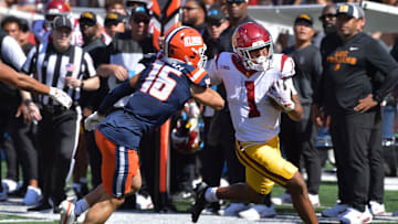 Sep 27, 2025; Champaign, Illinois, USA;  Illinois Fighting Illini defensive back Tanner Heckel (16) pushes Southern California Trojans running back Eli Sanders (1) out of bounds on a run during the first half at Memorial Stadium. Mandatory Credit: Ron Johnson-Imagn Images