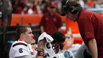Nov 15, 2014; Gainesville, FL, USA; South Carolina Gamecocks  co-offensive coordinator Steve Spurrier Jr. talks with quarterback Dylan Thompson (17) during the second half against the Florida Gators at Ben Hill Griffin Stadium. South Carolina Gamecocks defeated the Florida Gators 23-20 in overtime. Mandatory Credit: Kim Klement-Imagn Images