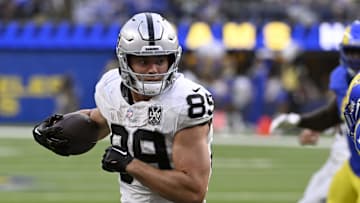 Oct 20, 2024; Inglewood, California, USA; Las Vegas Raiders tight end Brock Bowers (89) braces for contract with Los Angeles Rams safety Quentin Lake (37) during the second half at SoFi Stadium. Mandatory Credit: Alex Gallardo-Imagn Images