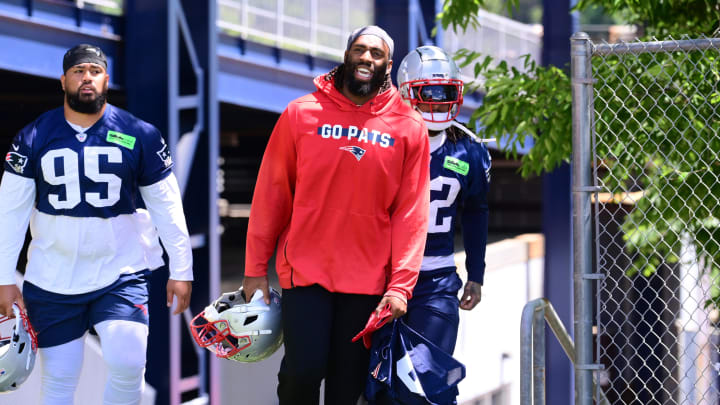 Jun 10, 2024; Foxborough, MA, USA;  New England Patriots linebacker Matthew Judon (9) (red) heads to the practice field at minicamp at Gillette Stadium. Mandatory Credit: Eric Canha-USA TODAY Sports