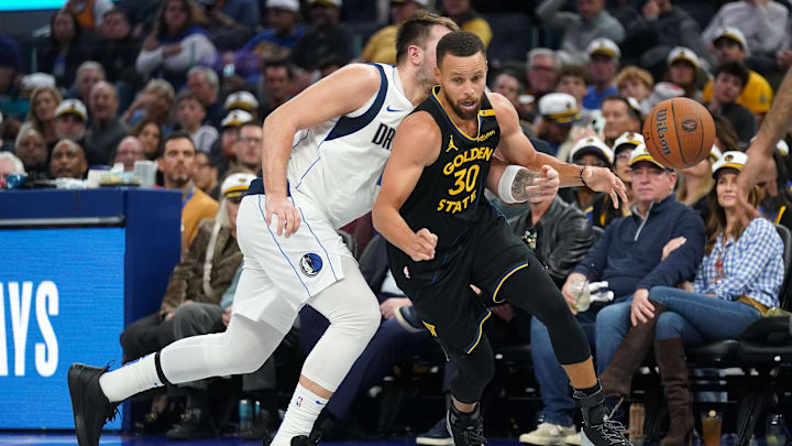 Nov 12, 2024; San Francisco, California, USA; Golden State Warriors guard Stephen Curry (30) has the ball knocked out of his hands by Dallas Mavericks guard Luka Doncic (77) in the third quarter at the Chase Center. Mandatory Credit: Cary Edmondson-Imagn Images