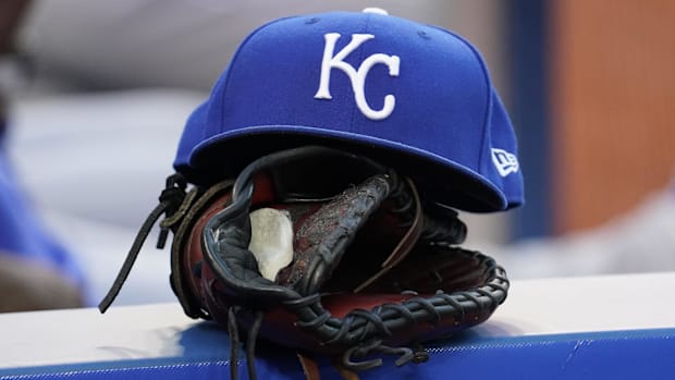 Blue Kansas City Royals hat on top of a black mitt