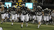 October 13, 2011; Orlando FL, USA; UCF Knights offensive linesman Phil Smith (75), fullback Brendan Kelly (40) and teammates run out of the tunnel prior to the game against the Southern Miss Golden Eagles during the first quarter of their game at Bright House Networks Stadium. Mandatory Credit: Kim Klement-Imagn Images