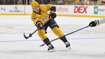 Oct 11, 2025; Nashville, Tennessee, USA;  Nashville Predators defenseman Justin Barron (20) passes the puck against the Utah Mammoth during the first period at Bridgestone Arena. Mandatory Credit: Steve Roberts-Imagn Images
