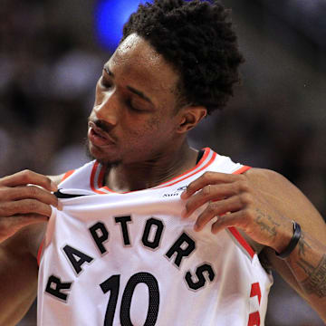 Apr 17, 2018; Toronto, Ontario, CAN; Toronto Raptors guard DeMar DeRozan (10) checks his jersey during a break in the action against the Washington Wizards in game two of the first round of the 2018 NBA Playoffs at Air Canada Centre. Toronto defeated Washington. Mandatory Credit: John E. Sokolowski-Imagn Images