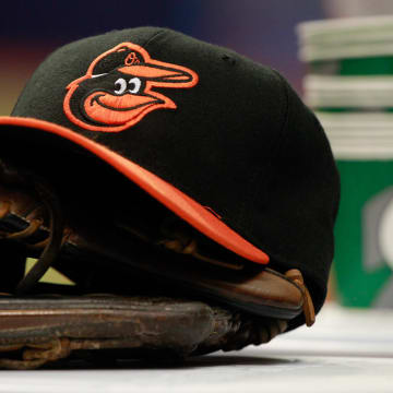 Apr 6, 2015; St. Petersburg, FL, USA; A general view of Baltimore Orioles glove and hat lays in the dugout against the Tampa Bay Rays at Tropicana Field.