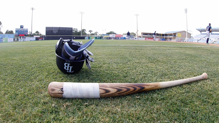 Dunedin, FL, USA; Tampa Bay Rays helmet and bat lay on the field before the game Toronto Blue Jays at TD Ballpark. Dunedin, FL, USA; Tampa Bay Rays helmet and bat lay on the field before the game Toronto Blue Jays at TD Ballpark.