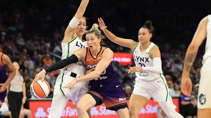 Jul 9, 2025; Phoenix, Arizona, USA; Minnesota Lynx forward Alanna Smith (8) and guard Kayla McBride (21) defend against Phoenix Mercury guard Sami Whitcomb (23) during the first half at PHX Arena. Mandatory Credit: Mark J. Rebilas-Imagn Images