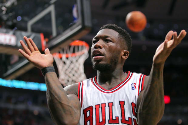 Ex-Husky Nate Robinson claps to excite the crowd in Chicago during the 2013 NBA Playoffs against the Miami Heat.