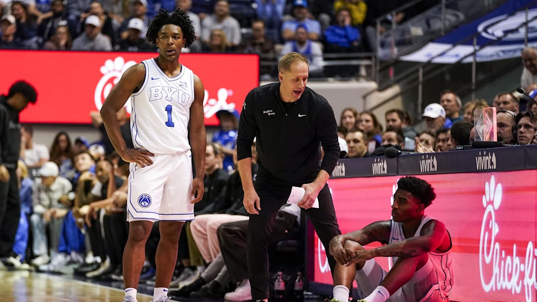 Jan 14, 2026; Provo, Utah, USA; BYU Cougars head coach Kevin Young speaks to BYU Cougars guard Robert Wright III (1)  and forward Kennard Davis Jr. (30) in the second half against the TCU Horned Frogs  at Marriott Center. Mandatory Credit: Aaron Baker-Imagn Images