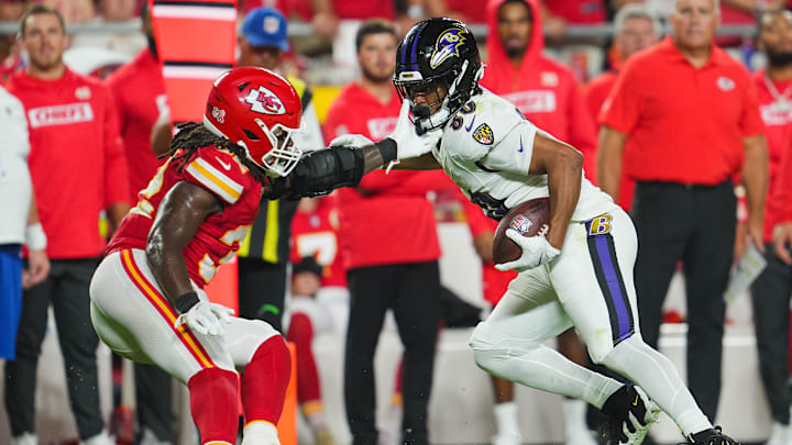 Sep 5, 2024; Kansas City, Missouri, USA; Baltimore Ravens tight end Isaiah Likely (80) runs with the ball against Kansas City Chiefs linebacker Nick Bolton (32) during the second half at GEHA Field at Arrowhead Stadium. Mandatory Credit: Jay Biggerstaff-Imagn Images