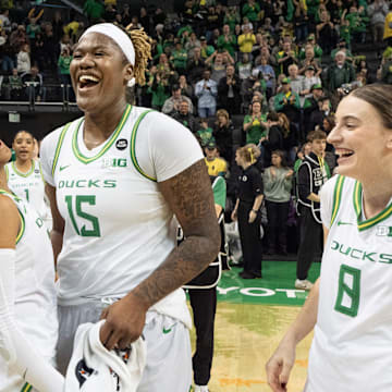 Oregon’s Oregon’s Peyton Scott, left, Deja Kelly, Phillipina Kyei and Elisa Mevius celebrate the Duck’s win over Rutgers at Matthew Knight Arena Sunday, Feb. 23, 2025 in Eugene, Oregon.