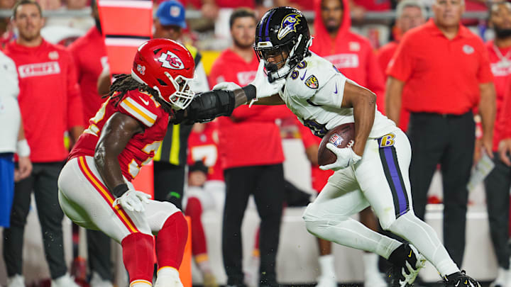 Baltimore Ravens tight end Isaiah Likely (80) runs with the ball against Kansas City Chiefs linebacker Nick Bolton (32) during the second half at GEHA Field at Arrowhead Stadium. 