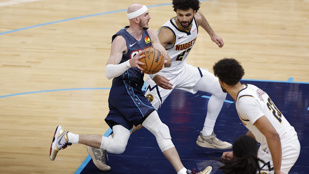 Feb 27, 2026; Oklahoma City, Oklahoma, USA; Oklahoma City Thunder guard Alex Caruso (9) drives to the basket between Denver Nuggets guard Jamal Murray (27) and forward Cameron Johnson (23) during the fourth quarter at Paycom Center.