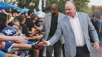 Kentucky football coach Mark Stoops greets the crowd at the team's Catwalk before the Vanderbilt game Saturday, Oct. 12, 2024 in Lexington, Ky. Behind him is associate head coach VInce Marrow.