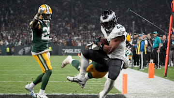Philadelphia Eagles running back Saquon Barkley (26) catches a touchdown against Green Bay Packers linebacker Isaiah McDuffie.