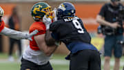 Jan 30, 2025; Mobile, AL, USA; National team offensive lineman Grey Zabel of North Dakota State (77) works against National team defensive lineman Darius Alexander of Toledo (9) during Senior Bowl practice for the National team at Hancock Whitney Stadium. Mandatory Credit: Vasha Hunt-Imagn Images
