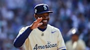 American League Futures manager Harold Reynolds high-fives a player following the third inning of the All Star-Futures Game at T-Mobile Park in 2023.