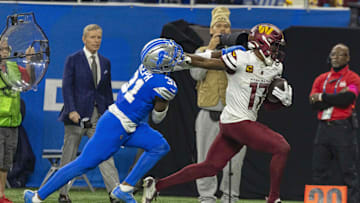 Jan 18, 2025; Detroit, Michigan, USA; Washington Commanders wide receiver Terry McLaurin (17) runs the ball against Detroit Lions safety Kerby Joseph (31)  during the second quarter at Ford Field. Mandatory Credit: David Reginek-Imagn Images